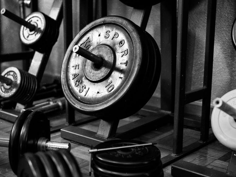 Atmospheric low light shot of a professional workout space with weights.