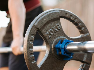 Man focusing on his grip before starting a heavy lift set.